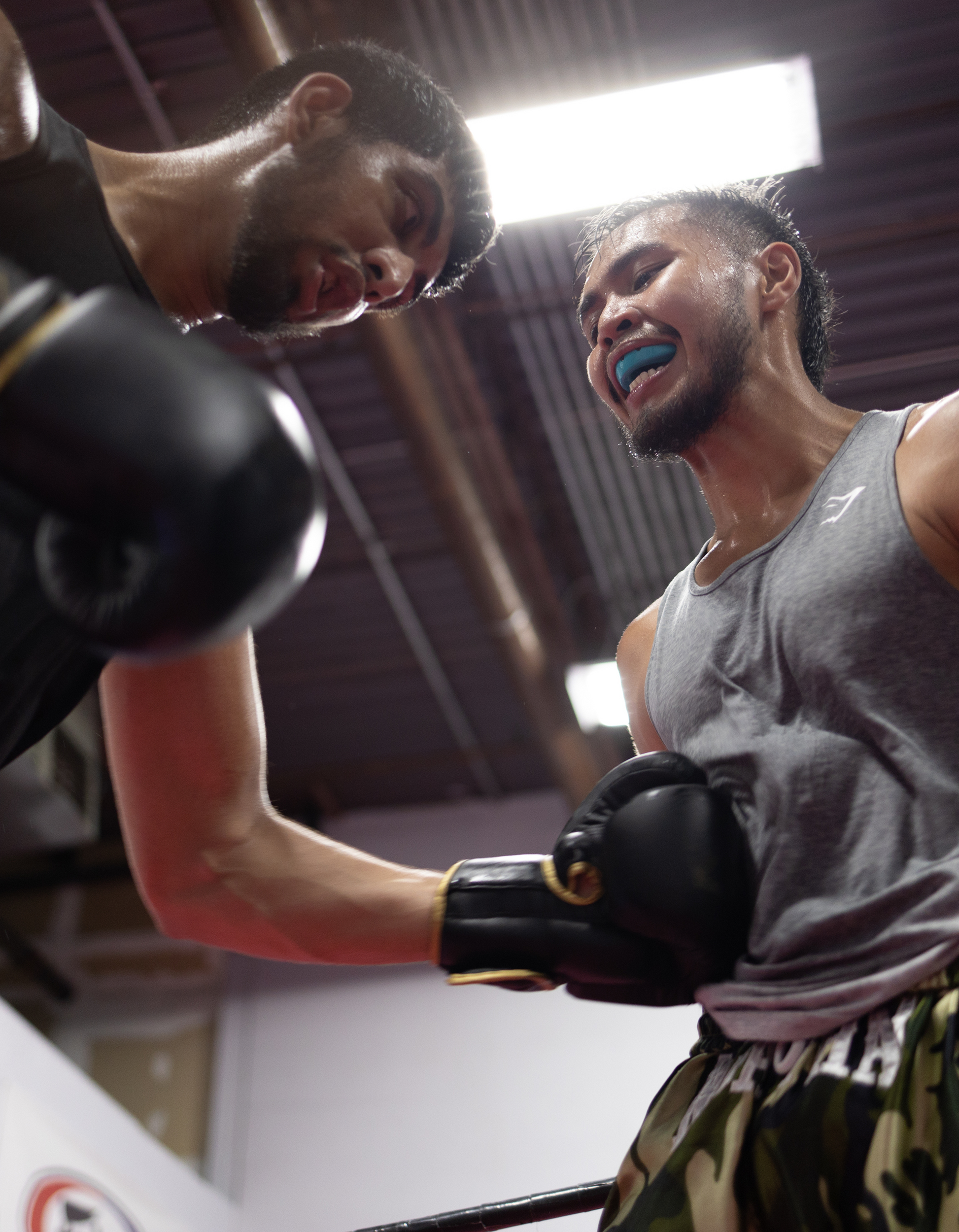 Image of two men sparring during a Muay Thai lesson at Ultimate Martial Arts & Fitness in Mississauga, Ontario, Canada