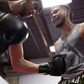 Image of two men sparring during a Muay Thai lesson at Ultimate Martial Arts & Fitness in Mississauga, Ontario, Canada