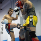 Image of two men sparring during a Muay Thai lesson at Ultimate Martial Arts & Fitness in Mississauga, Ontario, Canada. One man is kicking the other