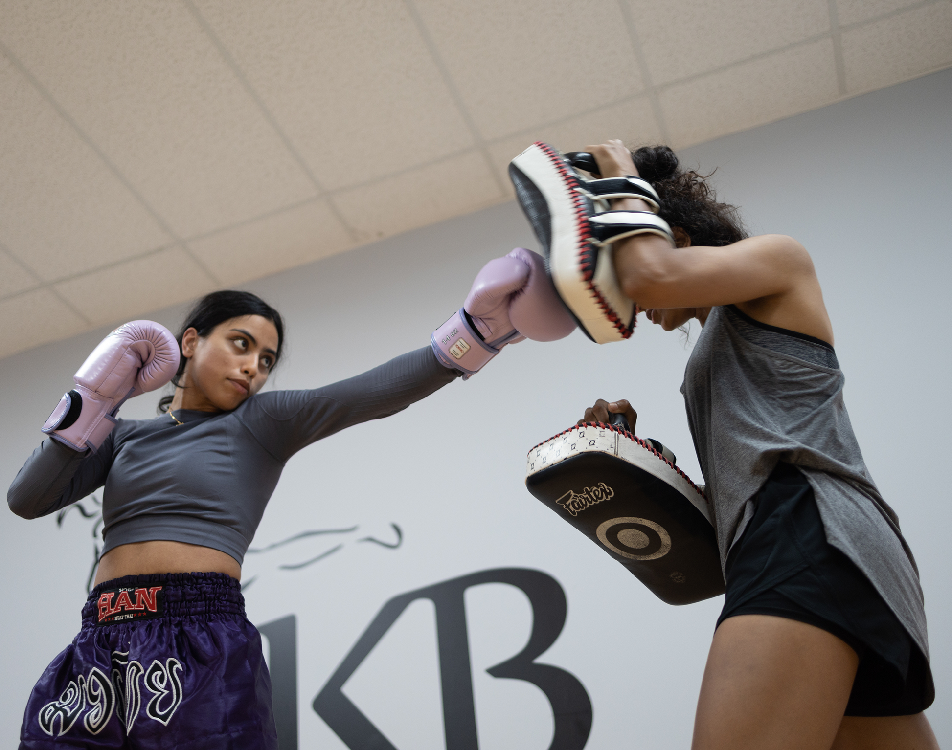 Image of two women practicing during a lesson at Ultimate Martial Arts & Fitness Muay Thai and kickboxing gym in Mississauga, Ontario, Canada